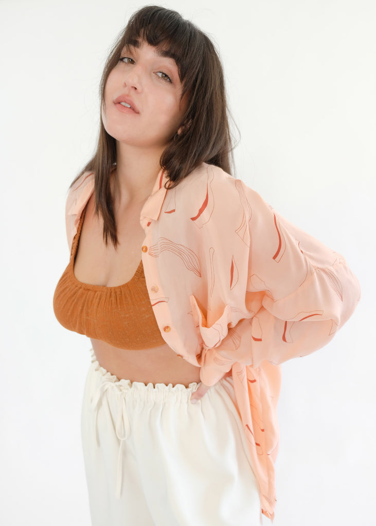 Girl wearing pink silk printed shirt and brown underwear set