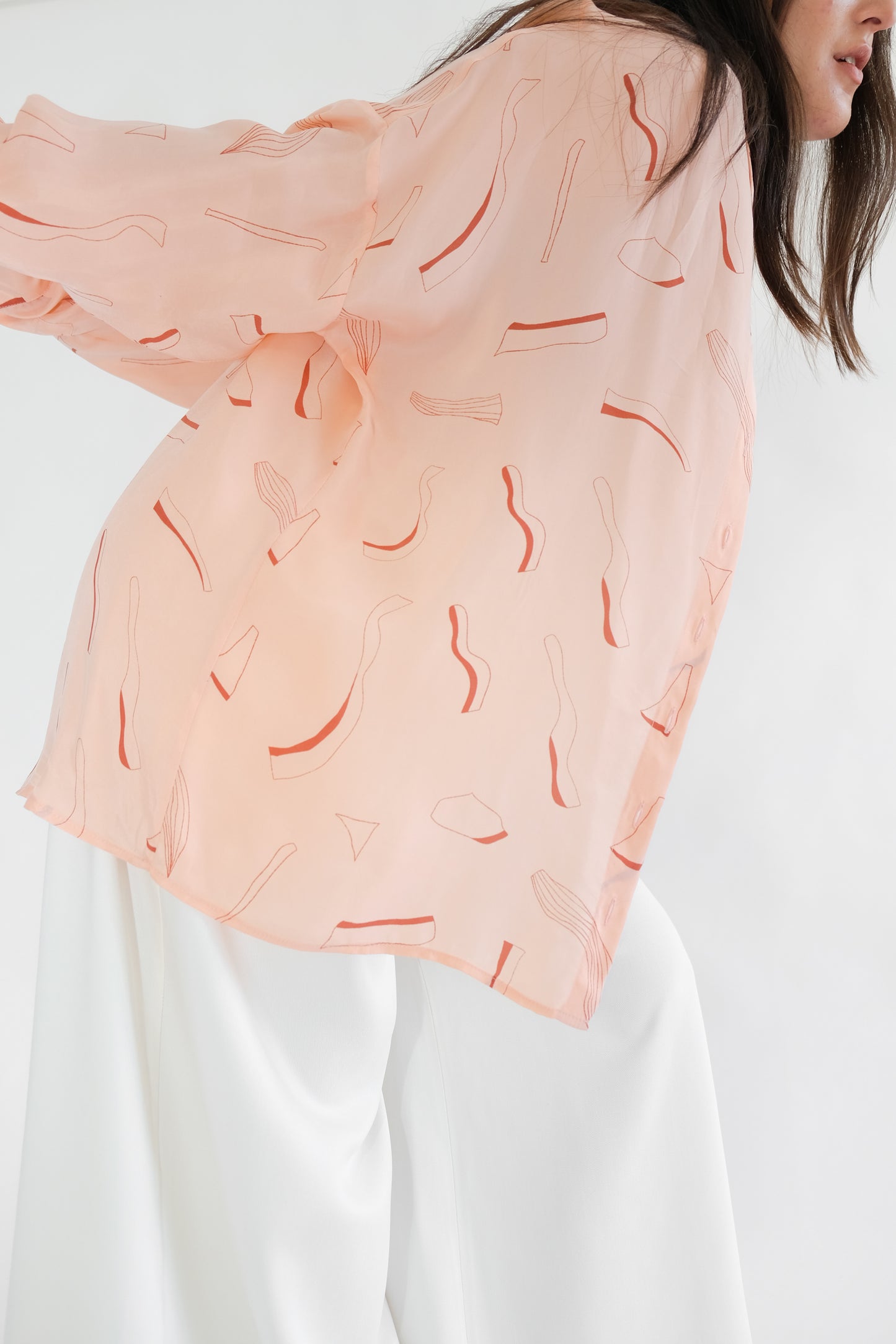 Girl wearing pink silk printed shirt