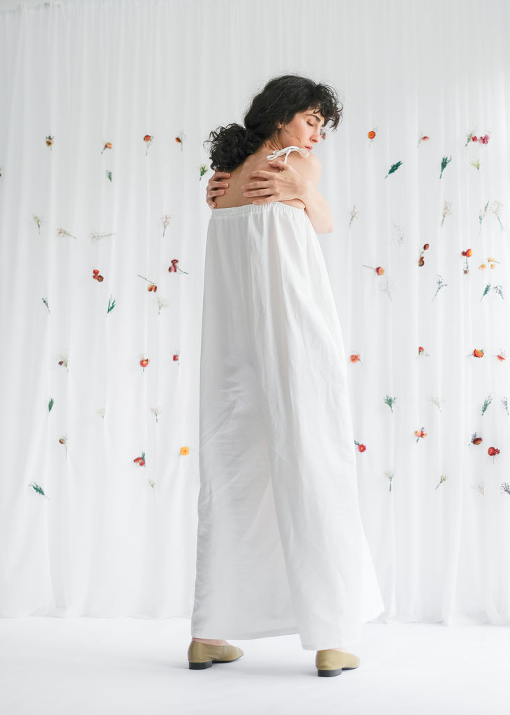 Back View of Sustainably Made Women's Wide Legged Relaxed Jumpsuit in White with elasticated neckline