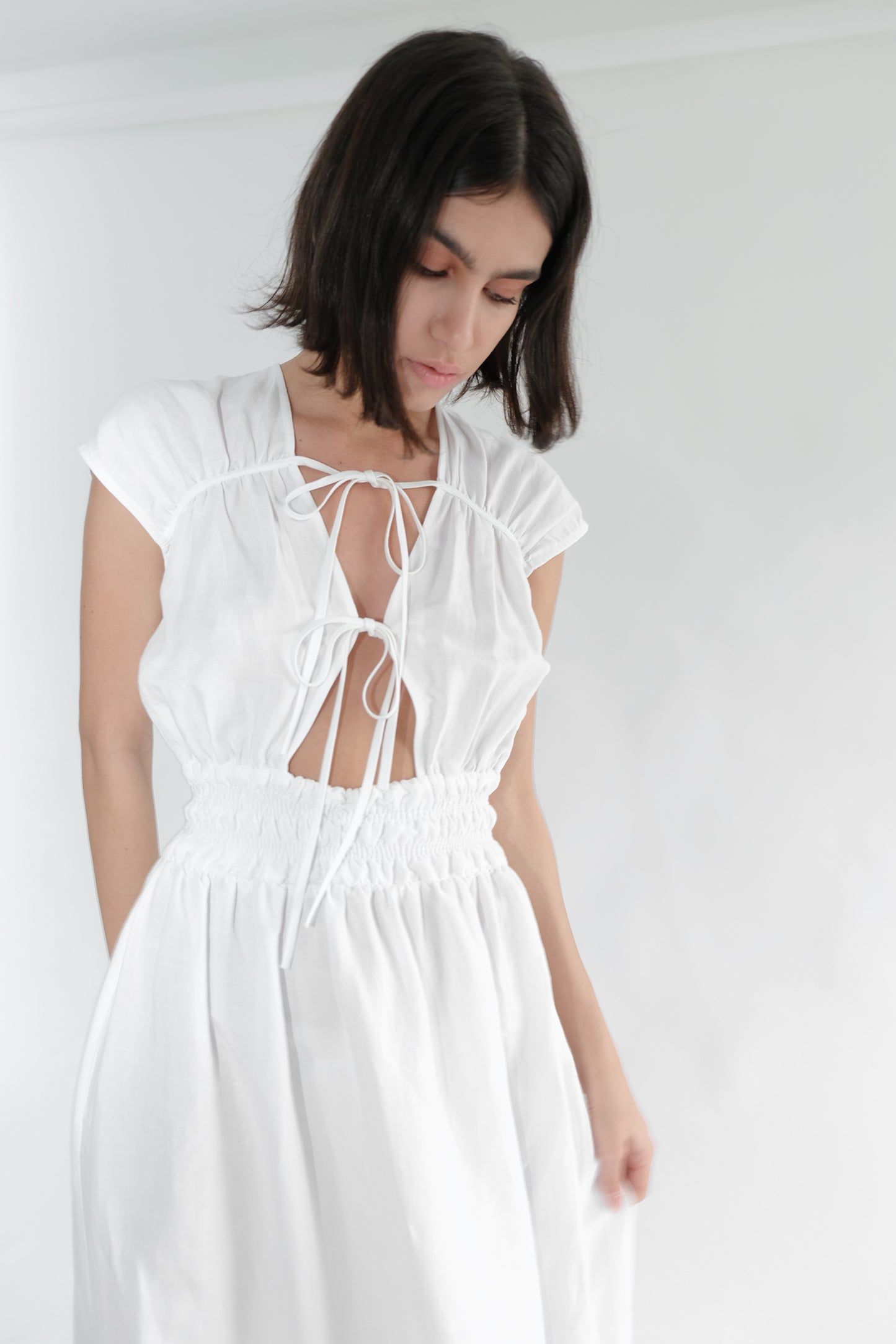 Girl standing wearing white midi dress