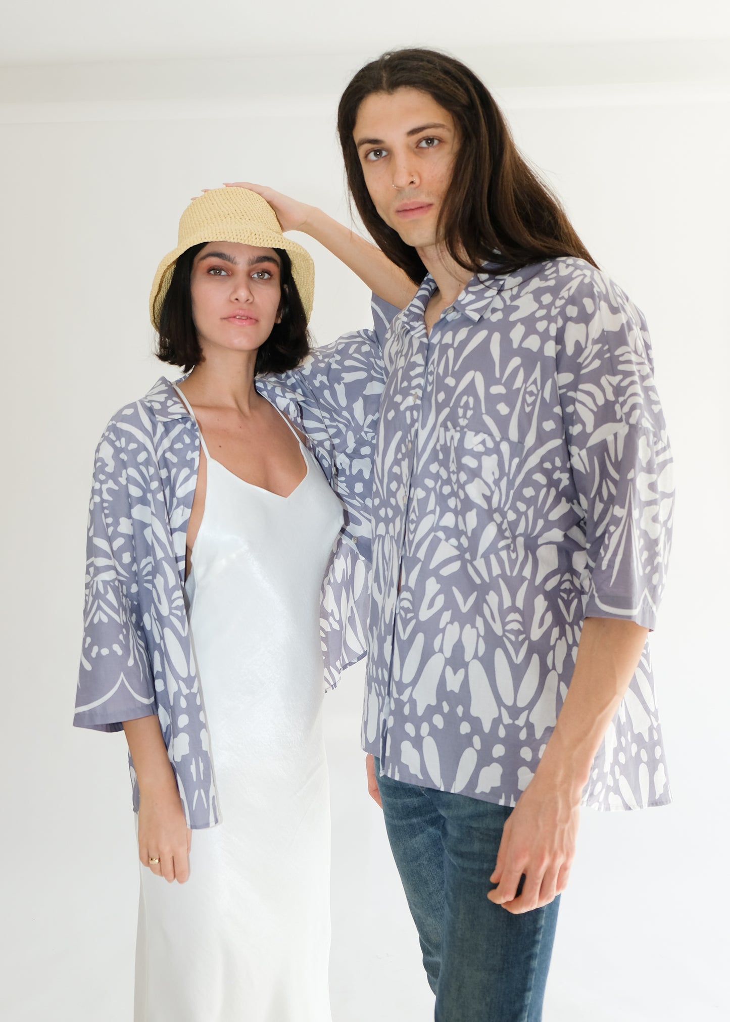 Guy and girl standing wearing cotton blue shirts