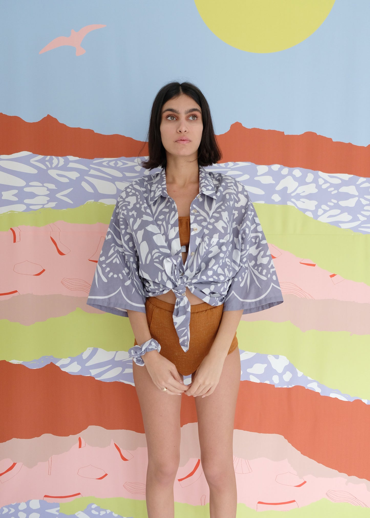 Girl standing wearing blue cotton shirt and brown underwear set