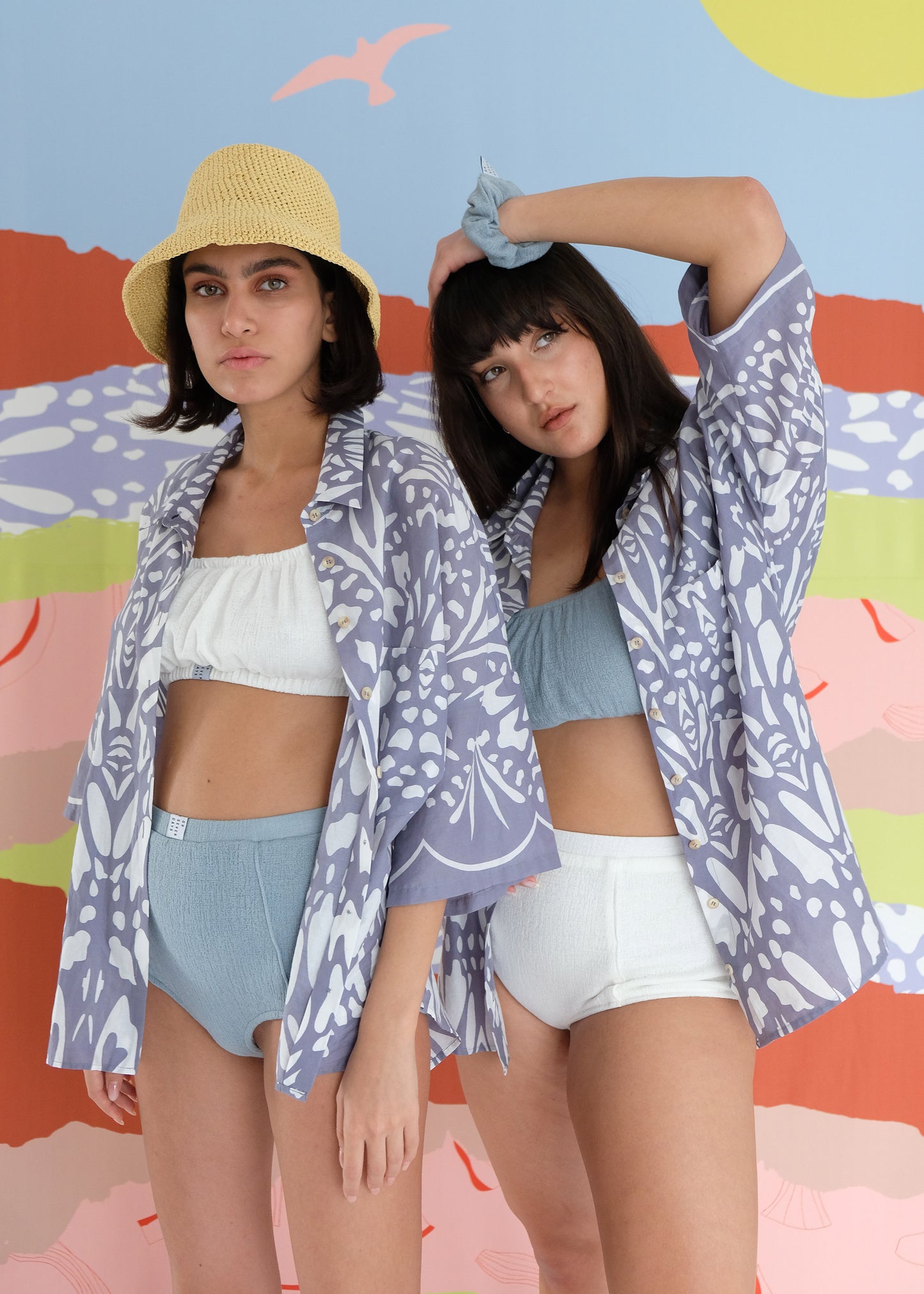 Two girls standing wearing cotton blue shirts and underwear sets