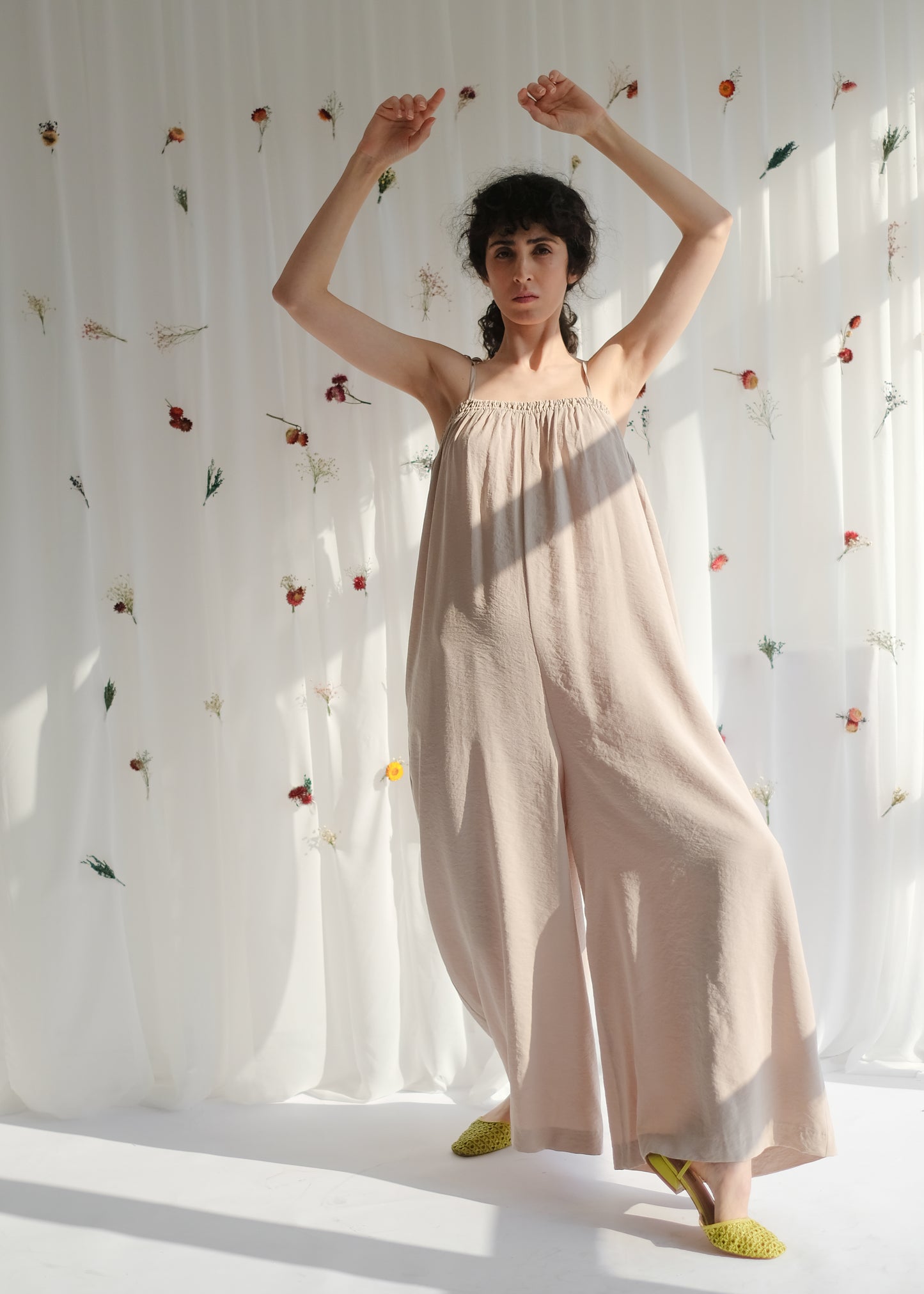 women's clothing, ethical clothing, dress, blouse, OhSevenDays, Girl standing with her hands in the air wearing a beige jumpsuit