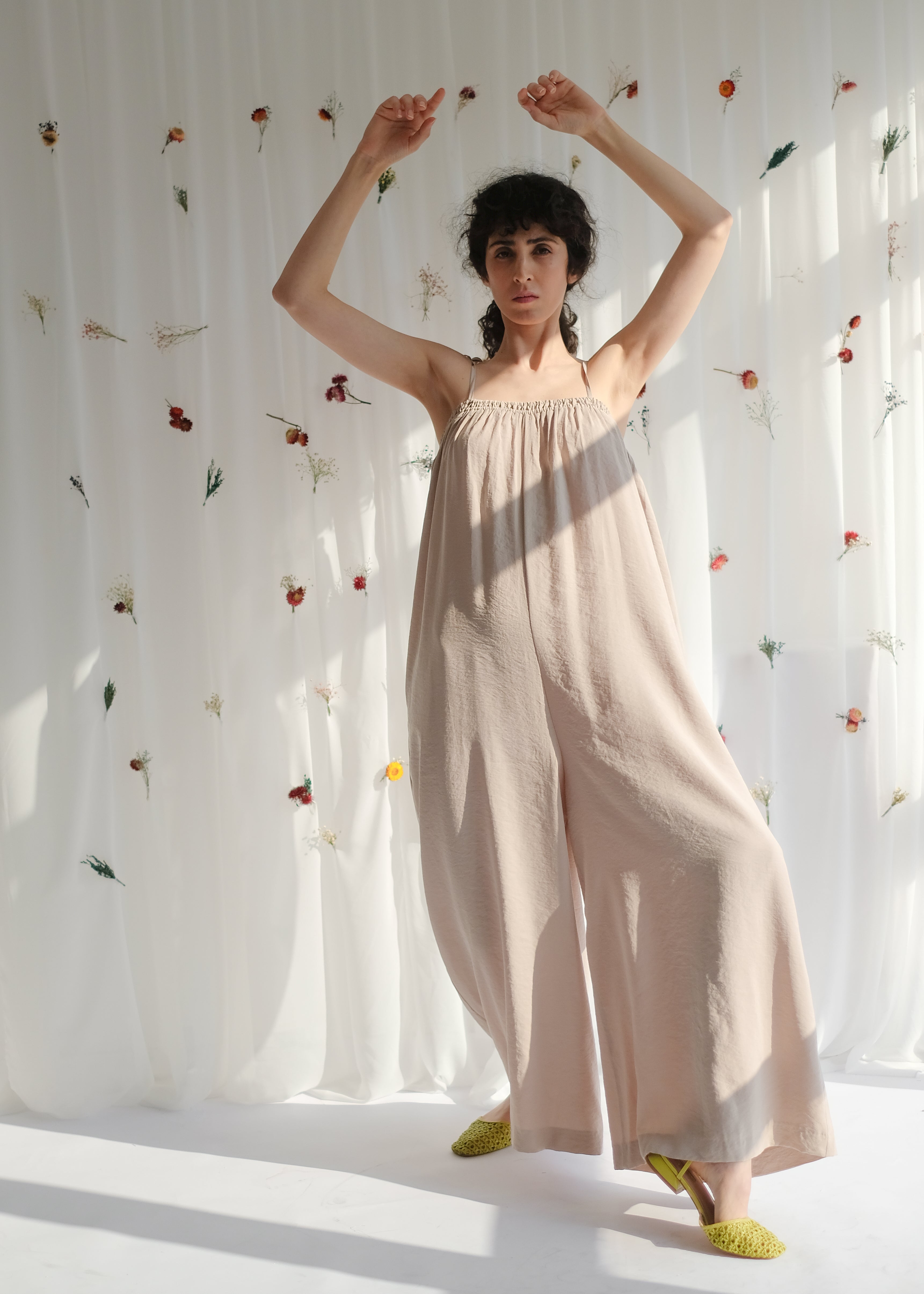 women's clothing, ethical clothing, dress, blouse, OhSevenDays, Girl standing with her hands in the air wearing a beige jumpsuit