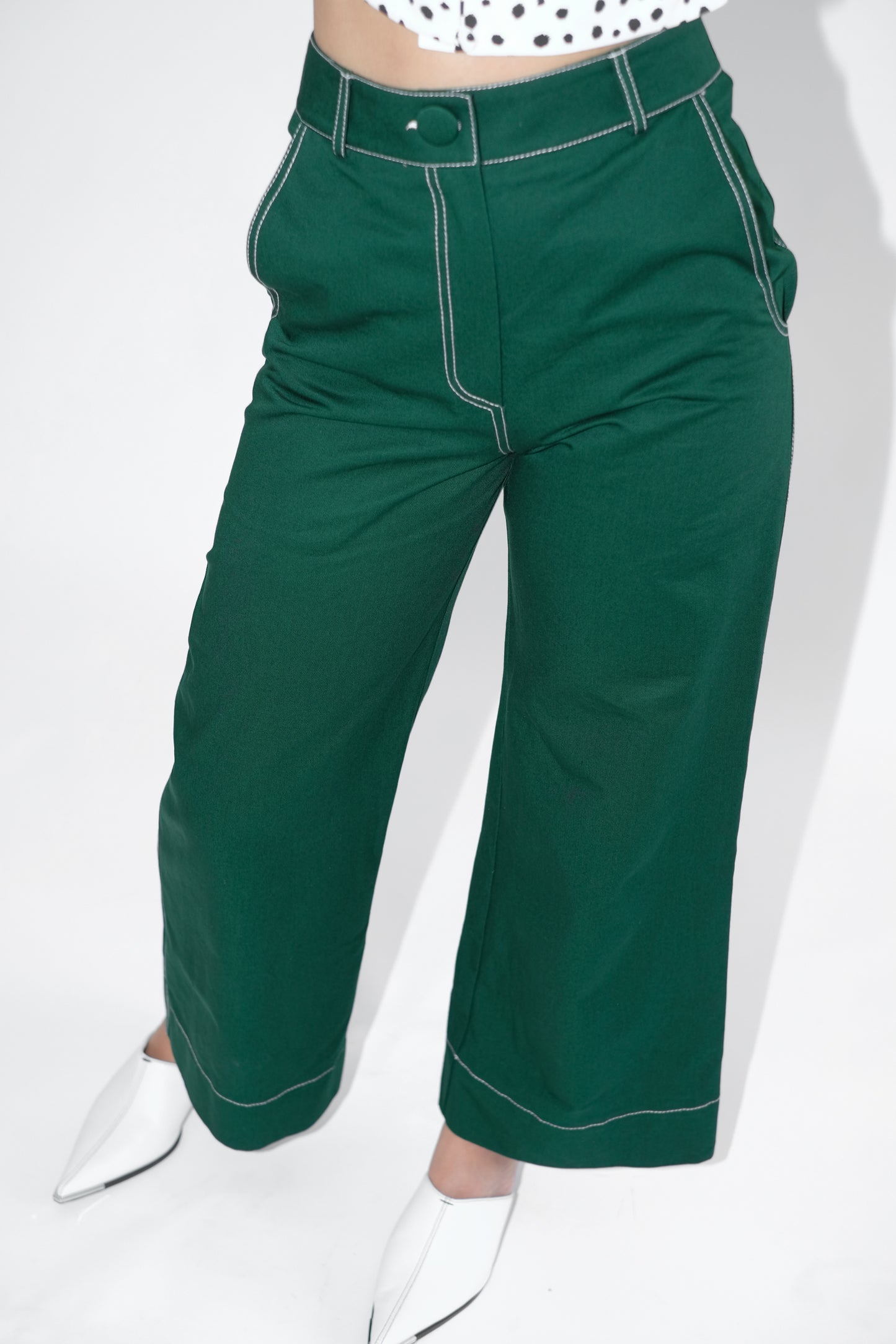 Close up of pine green flared trousers on woman