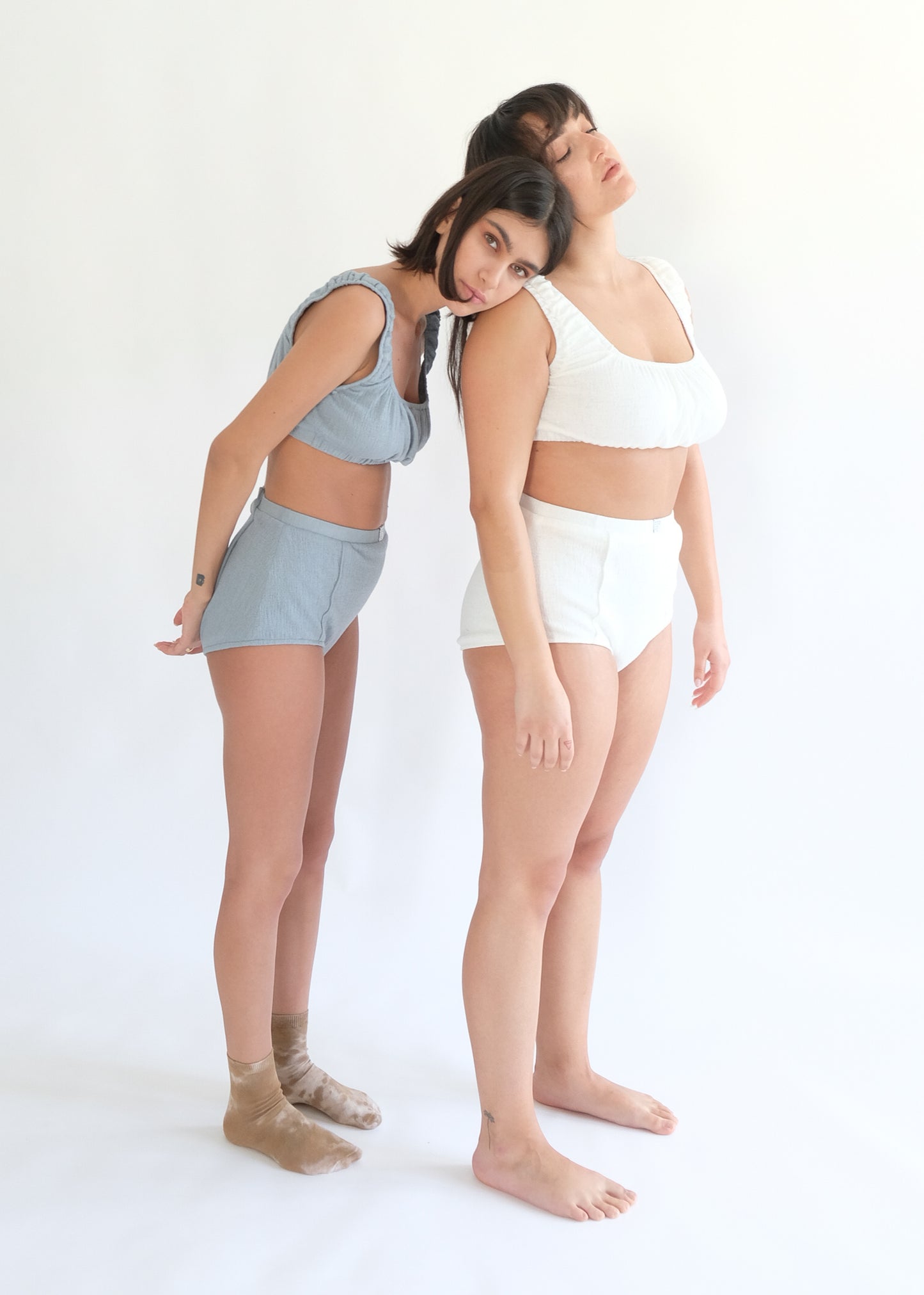 Girl standing wearing white and blue underwear set