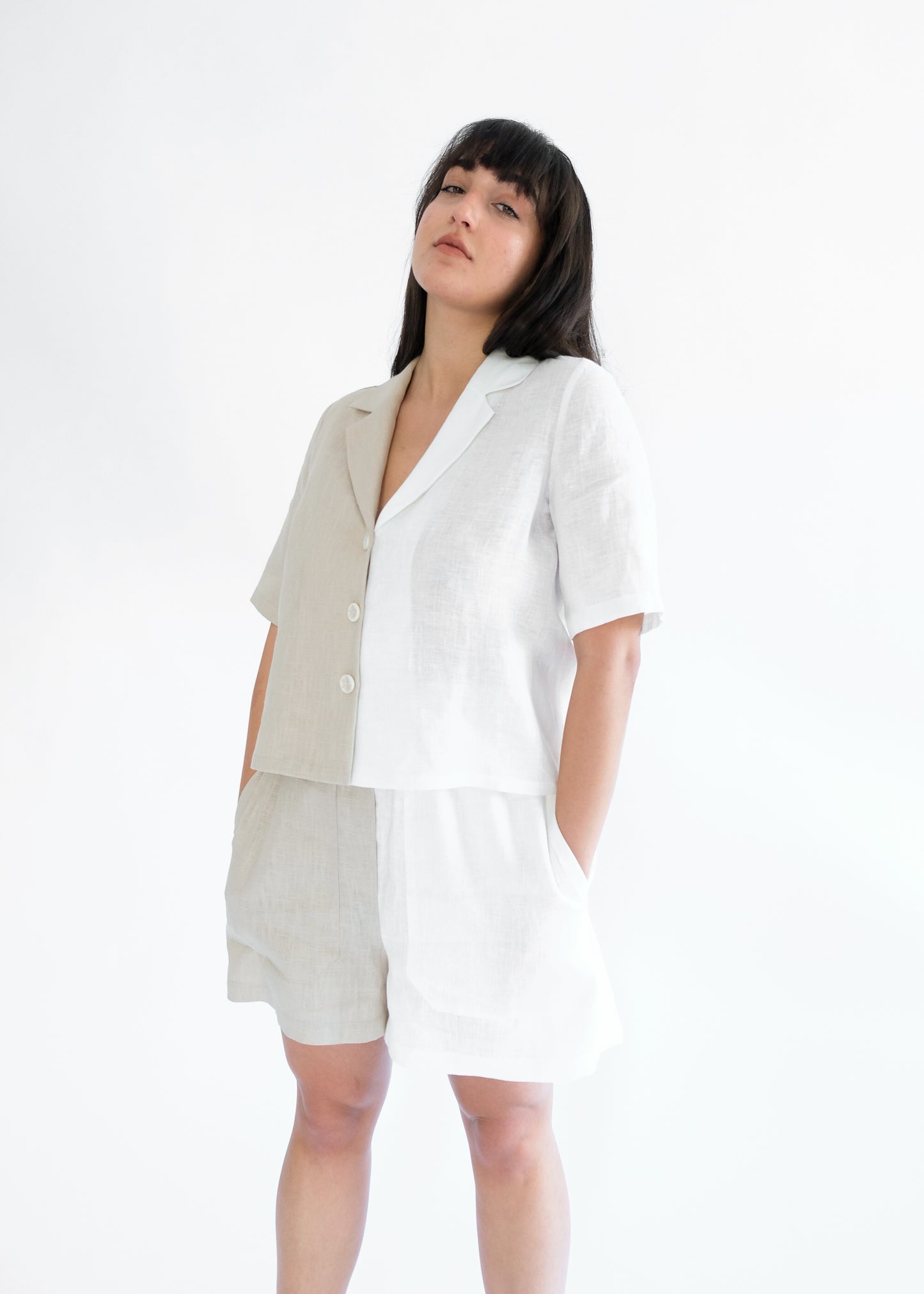 Girl standing wearing white and brown shirt and shorts