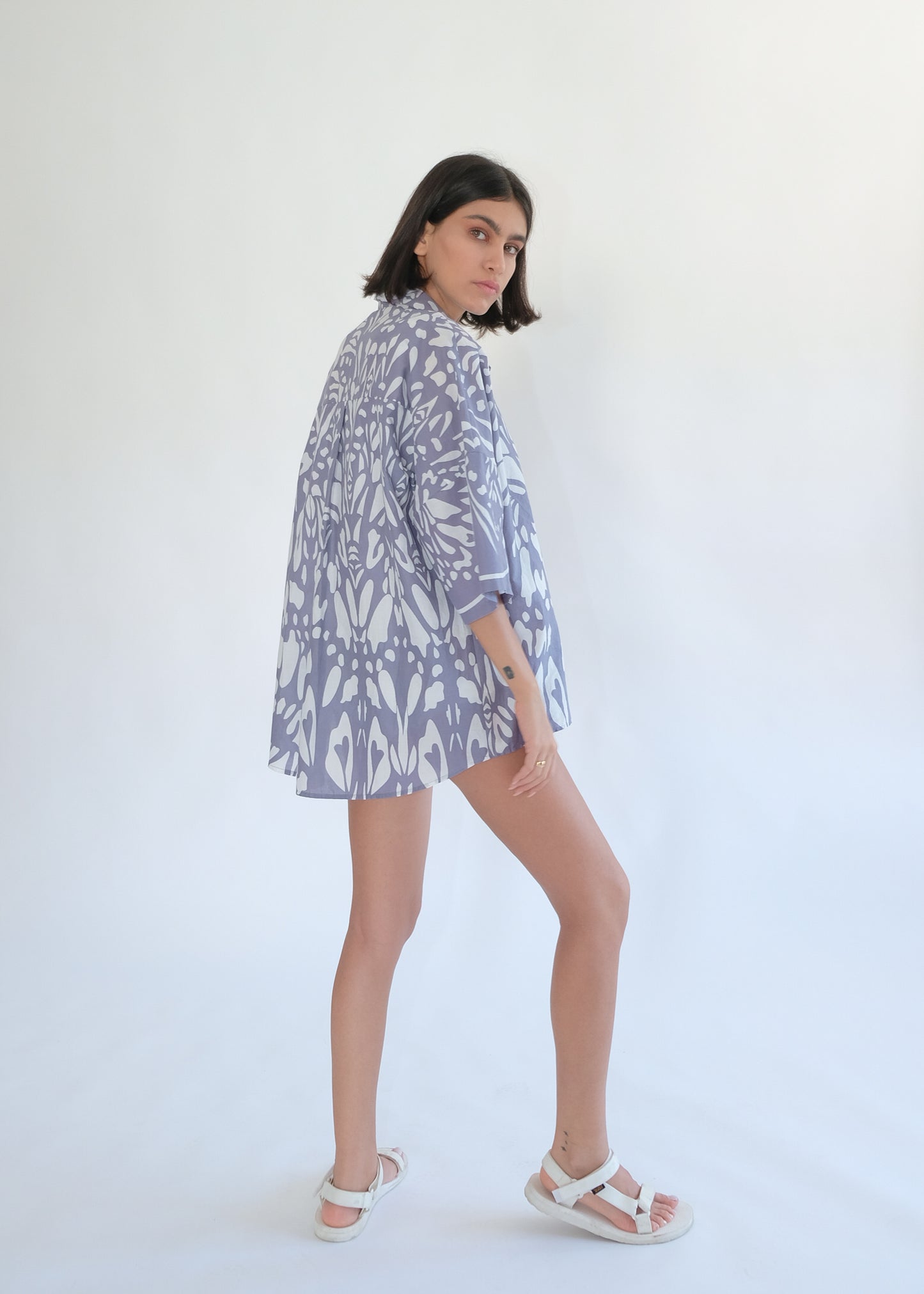 Girl standing backwards and wearing cotton blue shirt