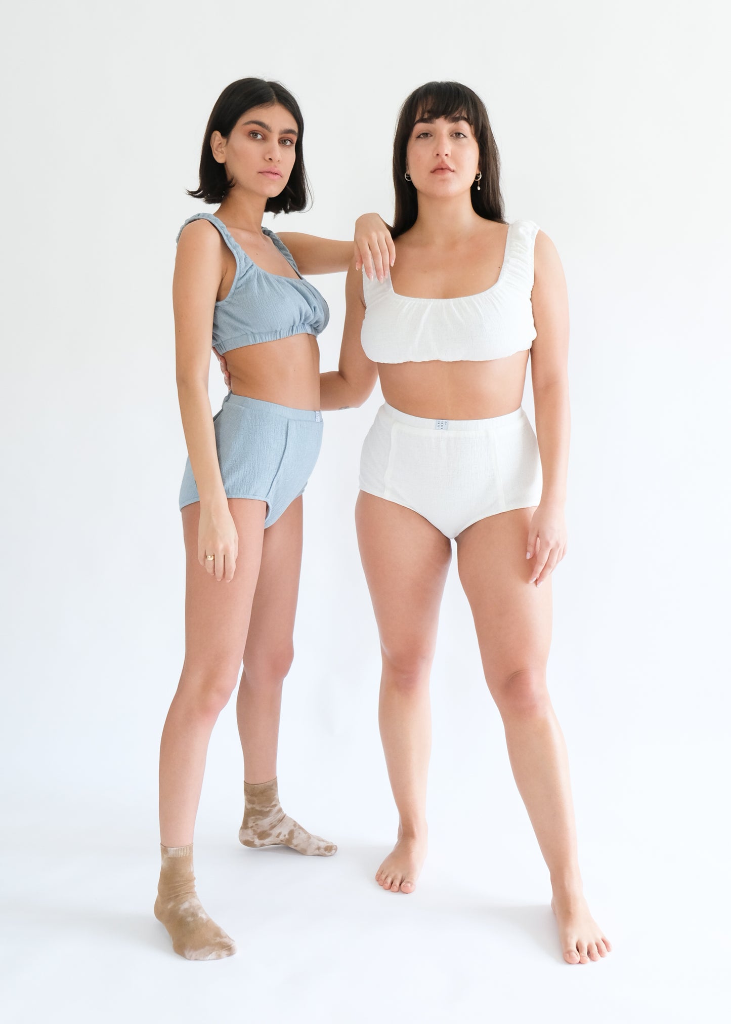 Girl standing wearing white and blue underwear set