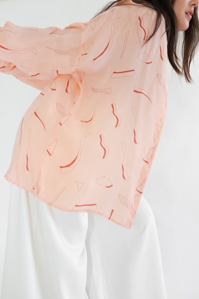 Girl wearing pink silk printed shirt 