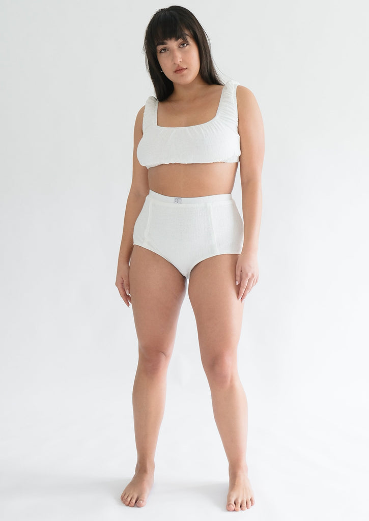 Girl standing wearing white underwear set