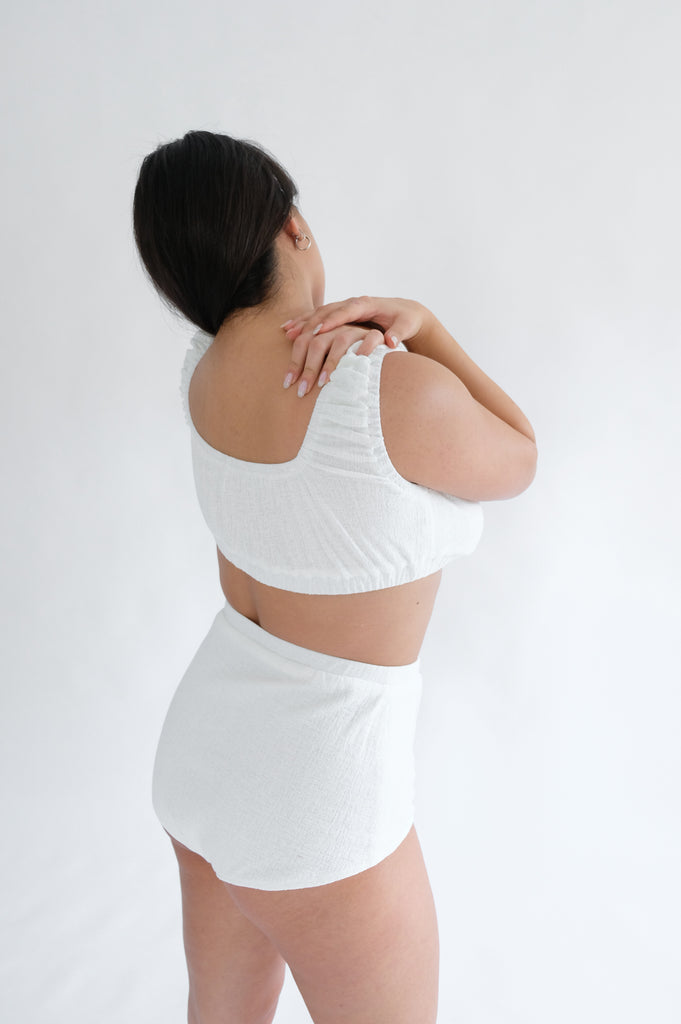 Girl standing backwards wearing white underwear set