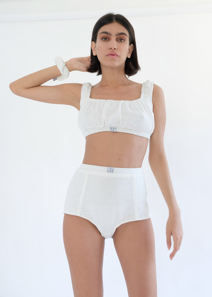 Girl standing wearing white underwear set 