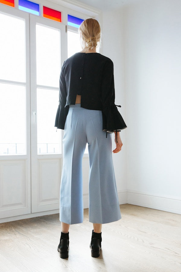  women's clothing, ethical clothing, dress, blouse, OhSevenDays, Back view of woman wearing black top and blue trousers
