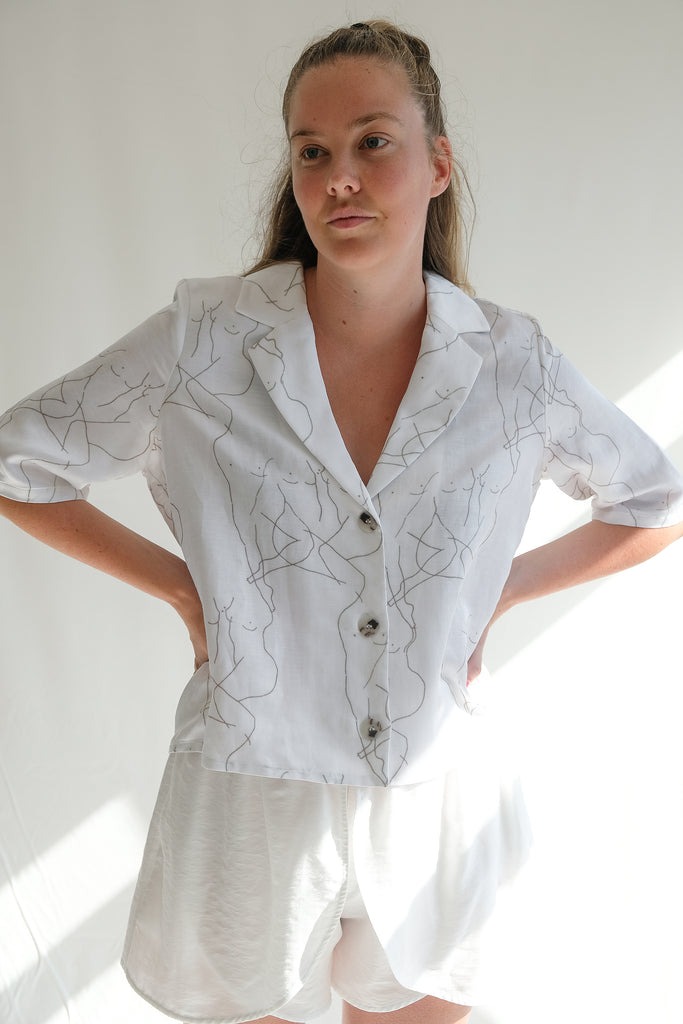 Woman wearing printed white shirt with white shorts