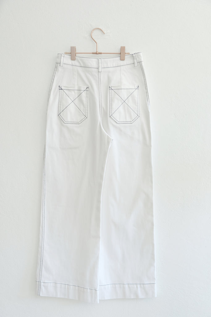 Back side of white wide legged pants on hanger